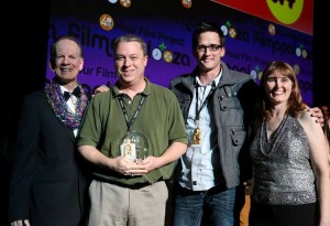 TL Westgate and co-star Hans Christianson accept their award for the best film in Orlando, from Mark Ruppert (far left) and Liz Langston.